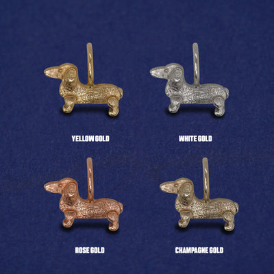 Four versions of the Dog Charm shown in options of yellow, white, rose, and champagne gold