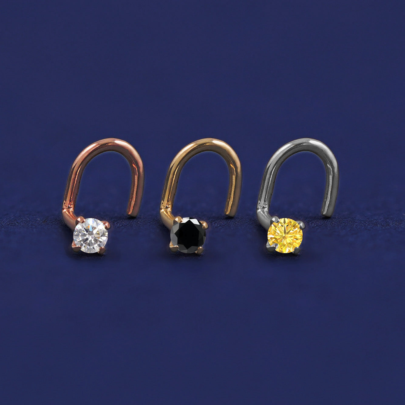 Three versions of the Diamond Nose Stud shown in options of rose, yellow, and white gold