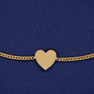 Reverse side of the Enamel Heart Bracelet showing a solid yellow gold heart