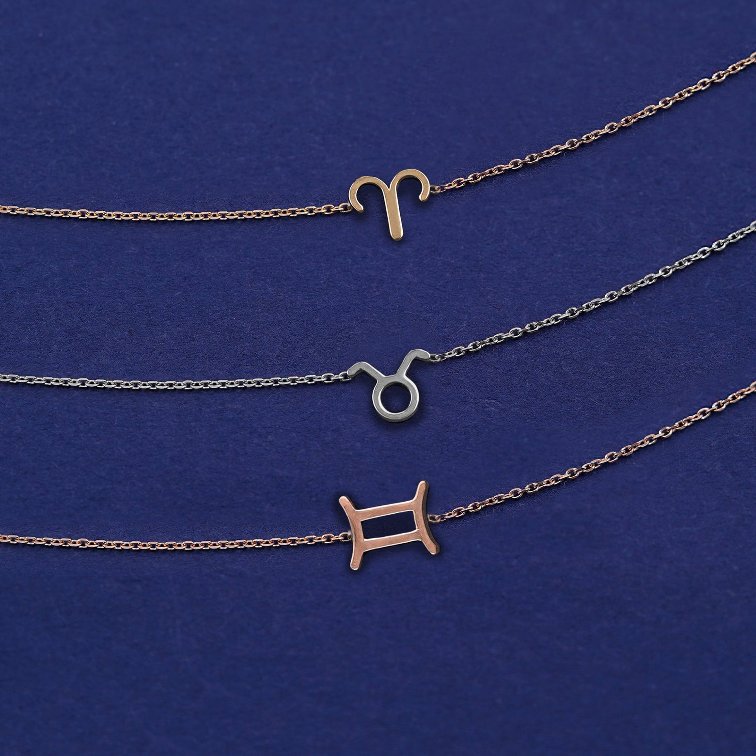 Three Horoscope Bracelets in zodiac symbols of Aries, Taurus and Gemini in yellow, white, and rose gold respectively