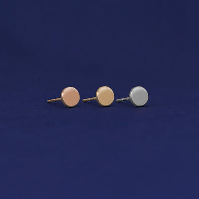 Three versions of the Large Circle Earring shown in options of rose, yellow, and white gold