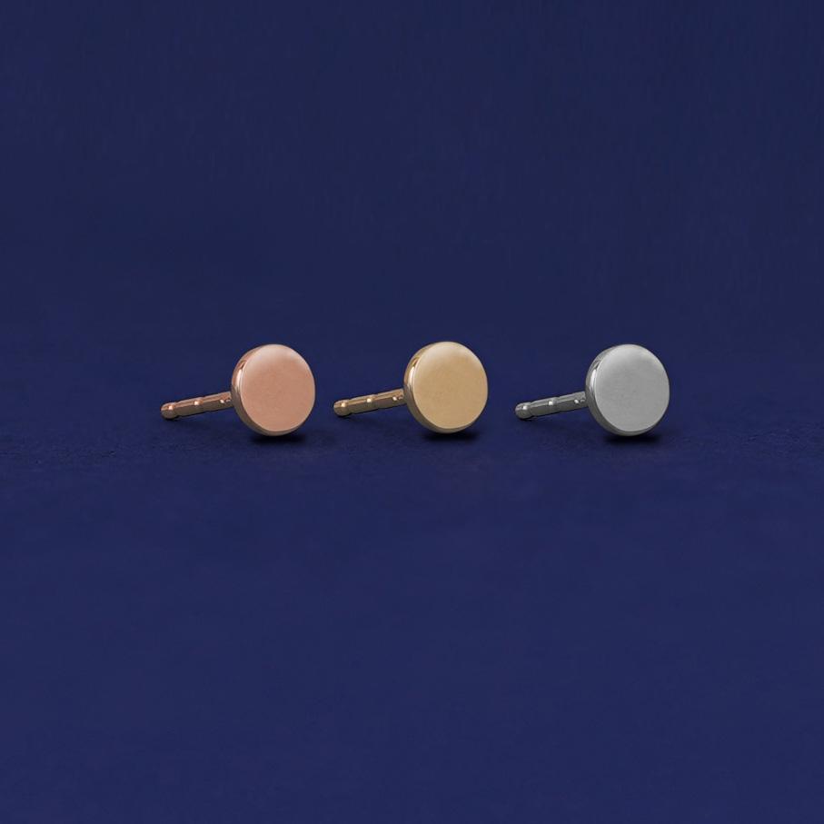 Three versions of the Medium Circle Earring shown in options of rose, yellow, and white gold