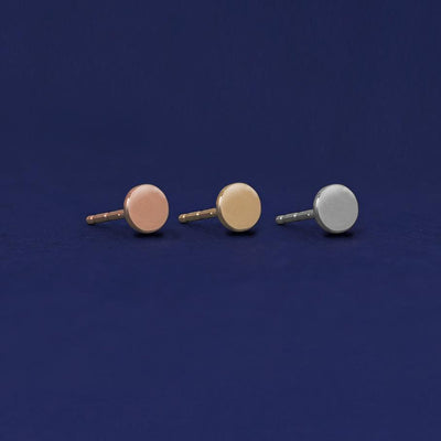 Three versions of the Medium Circle Earring shown in options of rose, yellow, and white gold