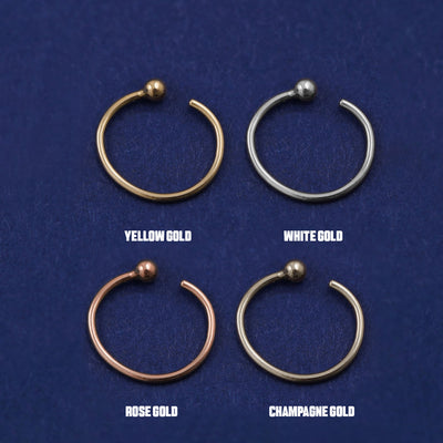 Four versions of the Nose Ring Hoop shown in options of yellow, white, rose and champagne gold