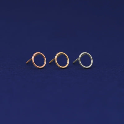 Three versions of the Open Circle Earring shown in options of rose, yellow, and white gold