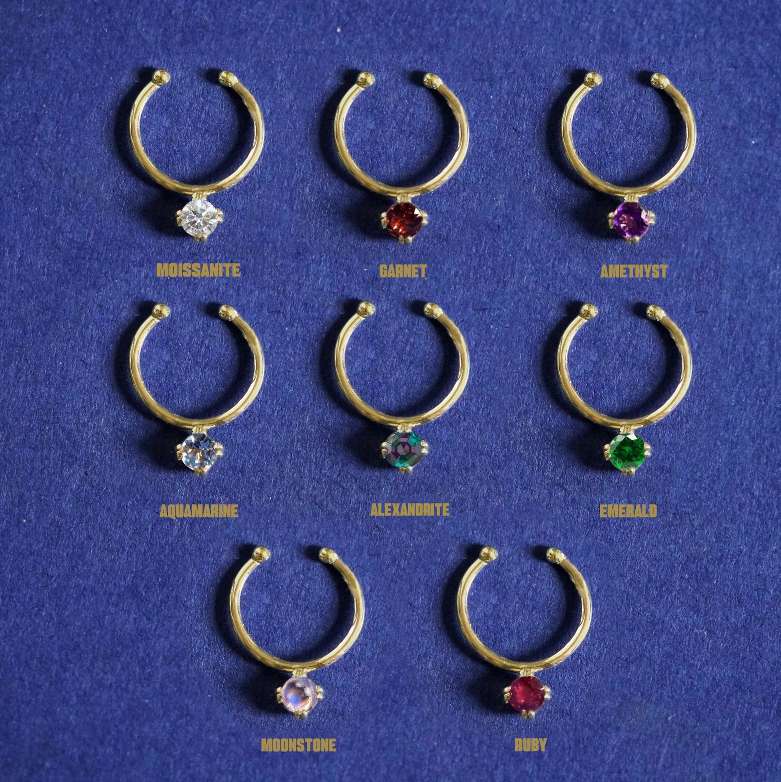 Gemstone Septum shown in options of Moissanite, Garnet, Amethyst, Aquamarine, Alexandrite, Emerald, Moonstone, and Ruby