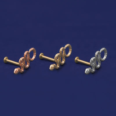 Three versions of the Snake Flat Back Earring shown in options of rose, yellow, and white gold