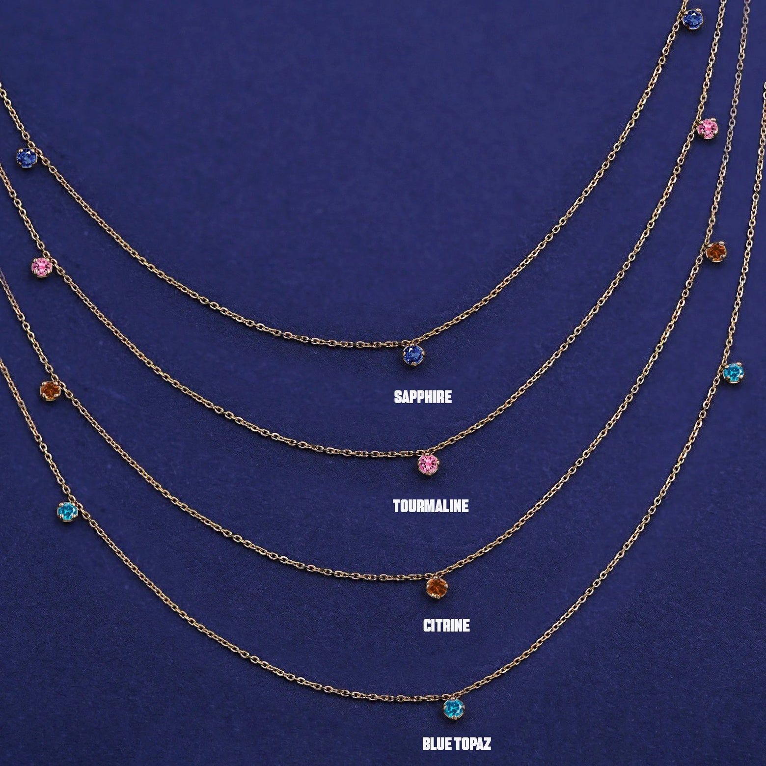 Four versions of the solid yellow gold 3 Gemstone Cable Necklace showing different birthstone options