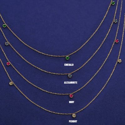 Four versions of the solid yellow gold 3 Gemstone Cable Necklace showing different birthstone options